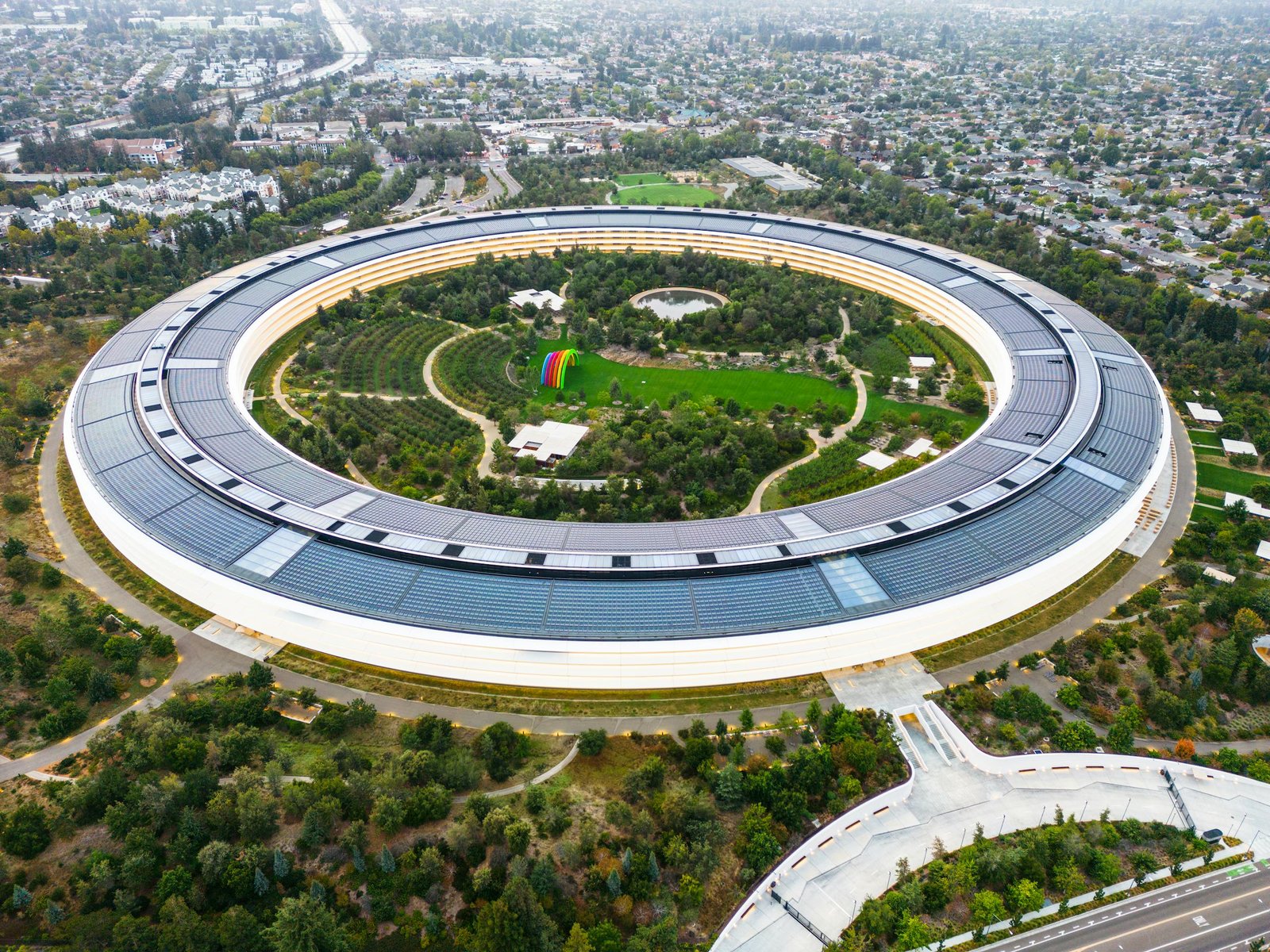 Stunning aerial view of the modern Apple Park in Cupertino, showcasing its unique circular design and lush greenery.